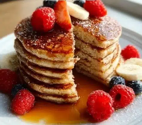 Best Protein Pancakes 9 Fluffy protein pancakes stacked with berries and syrup for a healthy breakfast