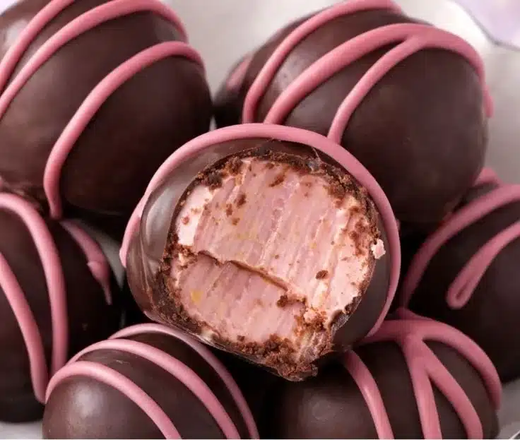 Chocolate Raspberry Truffles – Easy Valentine’s Treat 4 Decadent chocolate raspberry truffles on a decorative plate for Valentine's Day