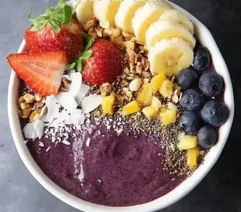 Delicious and nutritious bowl of acai topped with fruits and granola