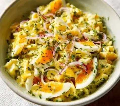 Foolproof egg salad served in a bowl with fresh herbs and spices