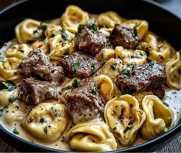 Delicious Garlic Steak Tortellini served with creamy sauce and fresh herbs