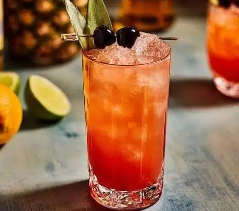 Rum Runner 4 Rum Runner cocktail served in a glass with tropical fruit garnish.