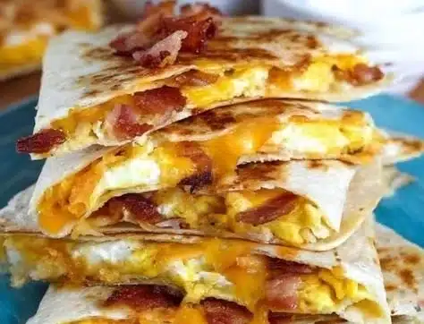 Bacon egg cheese breakfast quesadillas on a plate, ready to serve