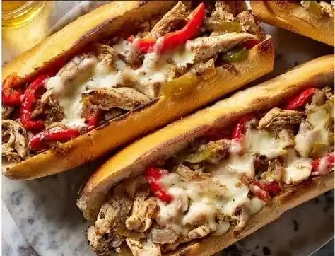 Mouthwatering Chicken Philly Cheese Steaks with melted cheese and fresh toppings