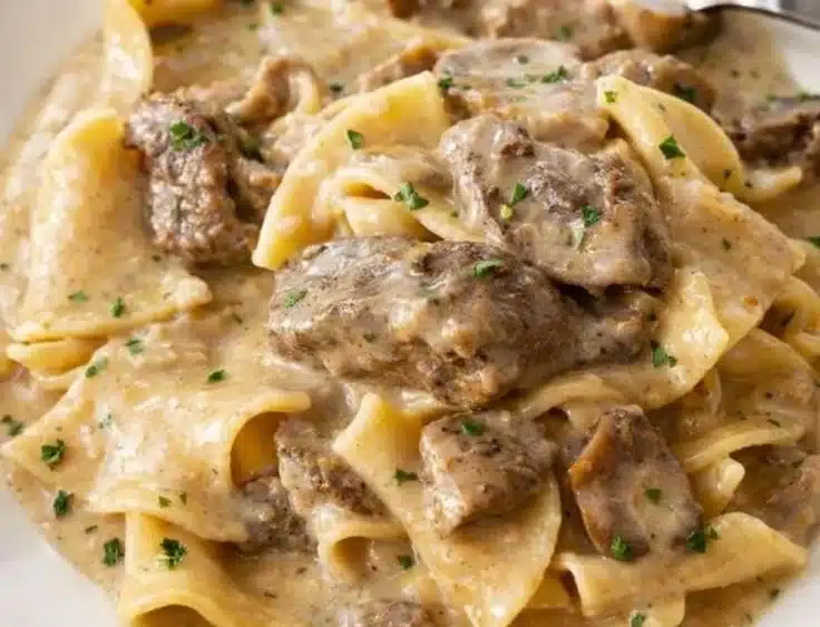 Slow Cooker Beef Stroganoff | Amazing Creamy Comfort 4 Delicious Slow Cooker Beef Stroganoff served on a plate with creamy sauce and mushrooms.