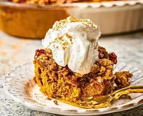 Delicious pumpkin dump cake served with whipped cream.