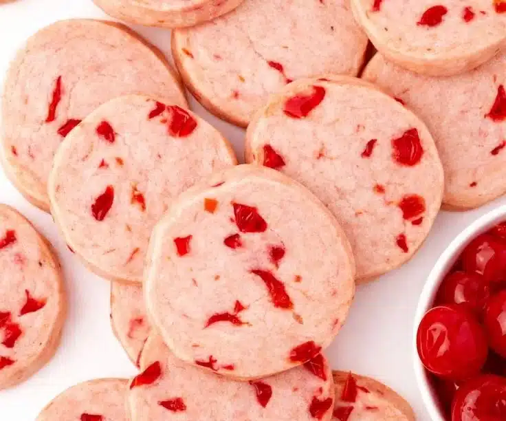 Freshly baked cherry almond shortbread cookies on a cooling rack