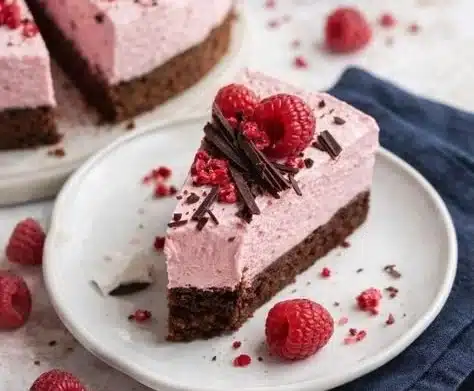 Delicious Chocolate Raspberry Mousse Cake with a rich chocolate layer and raspberry topping