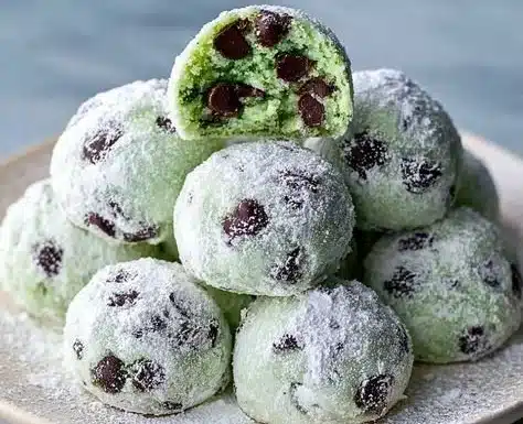 Easy Mint Chocolate Chip Snowball Cookies 4 Delicious easy mint chocolate chip snowball cookies on a plate.
