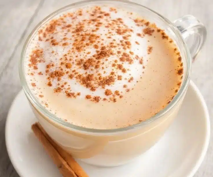 A comforting cup of homemade vanilla cinnamon milk tea topped with cinnamon.
