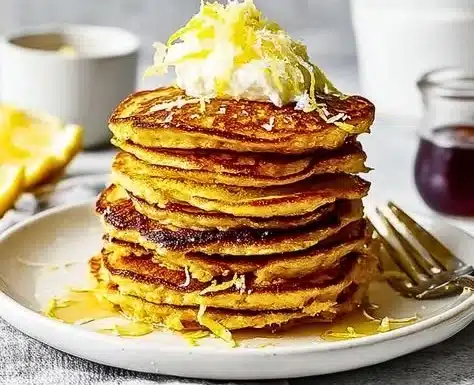 Lemon Ricotta Protein Pancakes 7 Delicious Lemon Ricotta Protein Pancakes stacked with fresh lemon zest