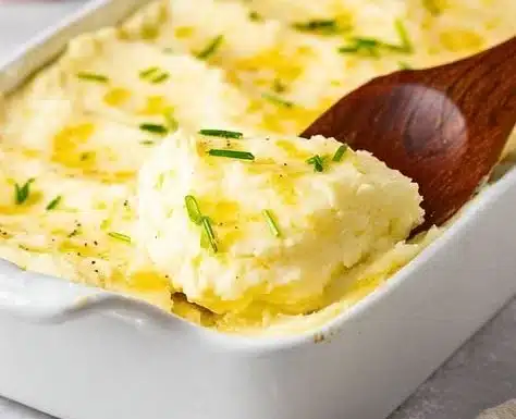 Delicious Mashed Potato Casserole topped with cheese and herbs
