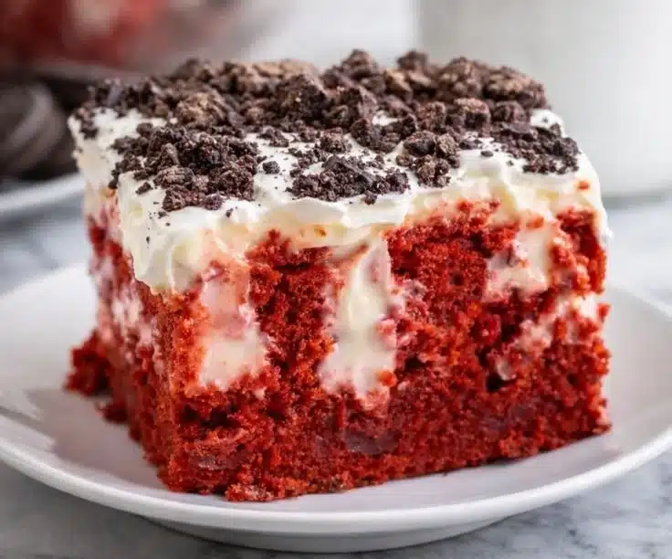Red Velvet Poke Cake topped with cream cheese frosting, perfect for Valentine's desserts