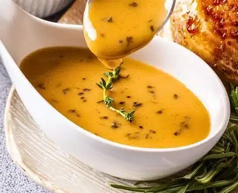 Rich and flavorful turkey gravy served with holiday turkey and mashed potatoes.