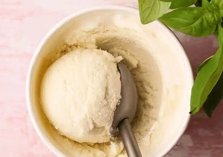 Delicious homemade basil ice cream served in a bowl with fresh basil leaves