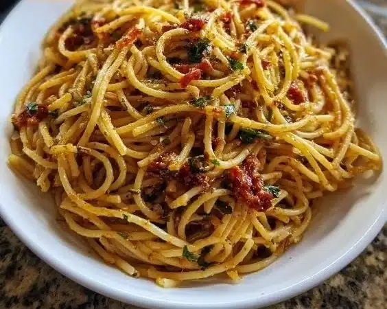 Charred Spicy Pasta Killer Spaghetti served in a bowl with fresh herbs