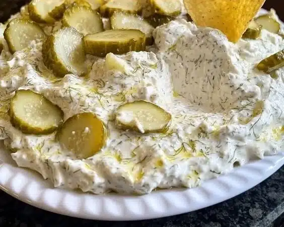 Homemade dill pickle dip served with crackers and veggies