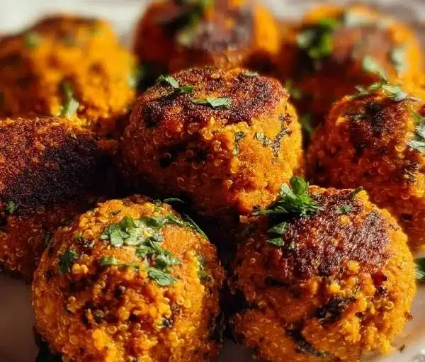 Plate of vegan sweet potato meatballs garnished with herbs